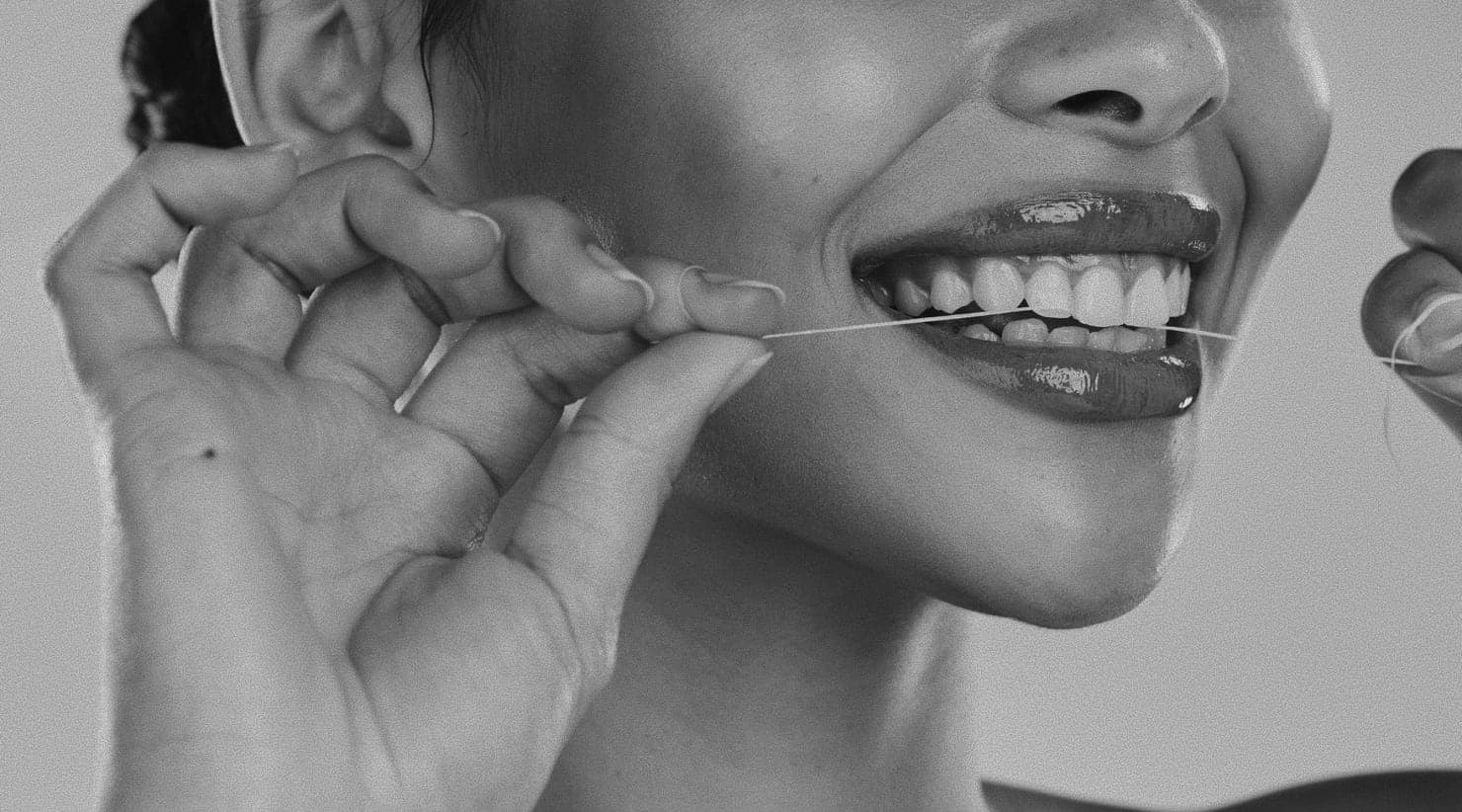 Woman flossing her teeth